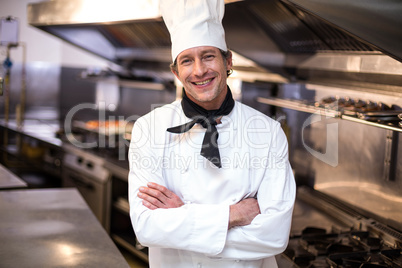 Handsome chef leaning on counter