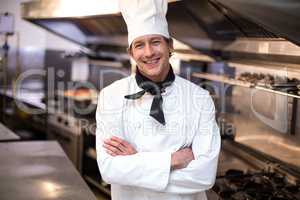 Handsome chef leaning on counter