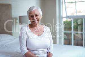 Portrait of confident senior woman on bed