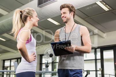 Trainer talking to woman after a workout