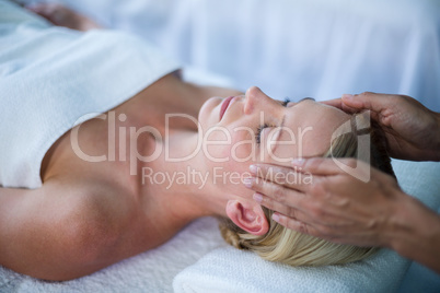 Woman receiving head massage from masseur