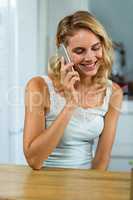 Smiling young woman talking on mobile