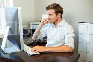 Young man working on computer at desk