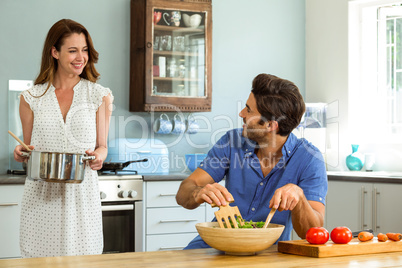Happy couple working in kitchen