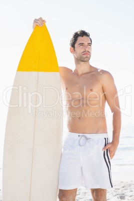 Man holding surfboard on the beach