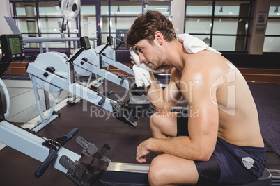 Tired man wiping his face after workout