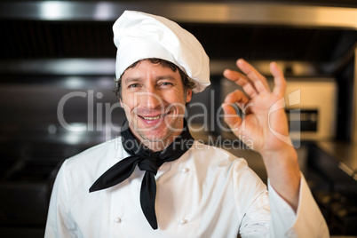 Portrait of happy male chef showing ok sign