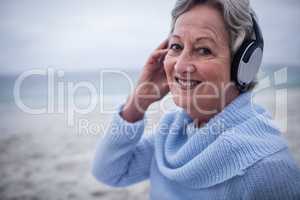 Portrait of senior woman listening to music on headphone