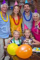 Portrait of smiling multi generation family celebrating birthday