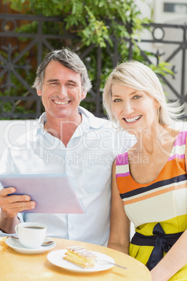 Portrait of happy couple with tablet