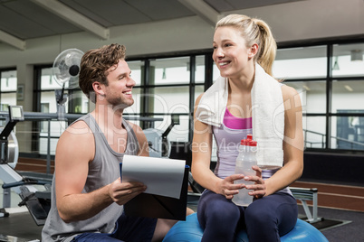 Woman talking to her trainer after a workout