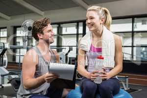 Woman talking to her trainer after a workout
