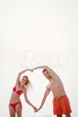 Couple forming a heart with arms