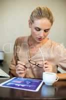 Young businesswoman looking at document on desk at office