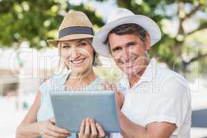 Portrait of couple using digital tablet