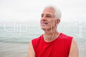 Thoughtful senior man looking away on beach