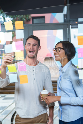 Colleagues looking at sticky notes