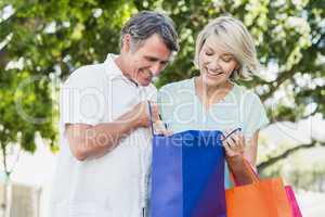 Happy couple looking in shopping bag