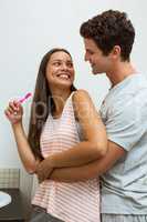 Couple hugging while brushing teeth