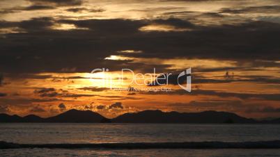 Mountain in the sea at sunset