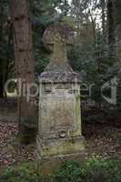 Overgrown grave stone