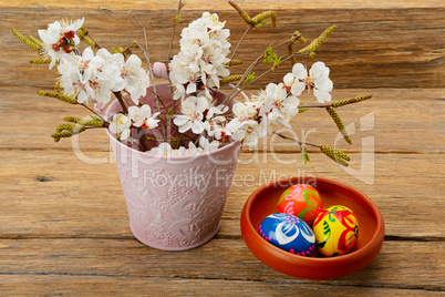 Easter eggs and twigs with flowers of apricot