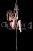 Blond woman prepare for split during pole dance
