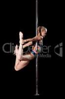 Blond woman during pole dance show exercise