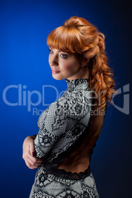 Portrait of red-haired model posing in dress