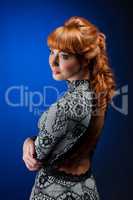 Portrait of red-haired model posing in dress