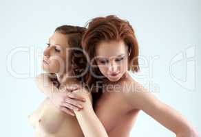 Portrait of beautiful naked girls cuddling