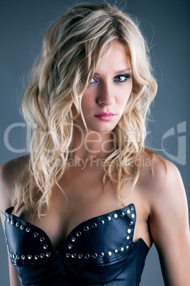 Portrait of charming young girl in leather corset