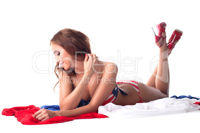 Smiling model shows swimsuit with american flag