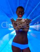 Mysterious young dancer posing with UV makeup