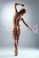 Image of naked slender woman with bronzed skin