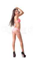 Beautiful slim model posing in pink swimsuit