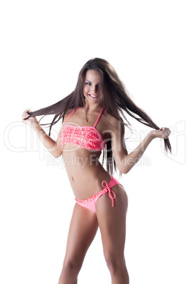 Cheerful long-haired girl posing in pink bikini