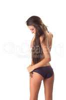 Long-haired girl shows swimsuit, back to camera