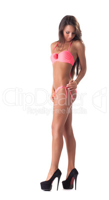 Sexy young girl posing in trendy pink bikini