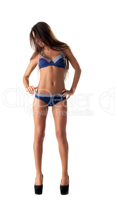 Shy leggy girl posing in fashionable swimsuit