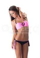 Slim girl with healthy skin posing in pink bikini