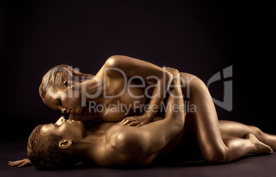 Image of sensual nude lovers with golden skin