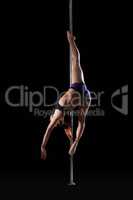 Flexible girl dancing on pilon, isolated black