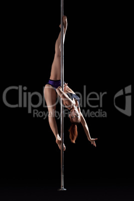 Young flexible woman dancing on pylon
