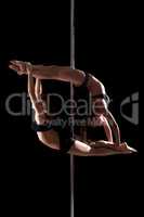 Duet of flexible young pole dancers