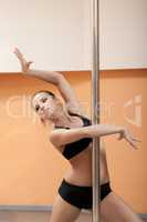 Portrait of emotional pretty pole dancer