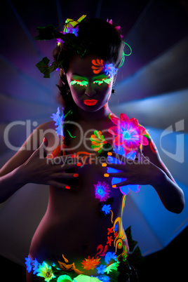 Naked woman with makeup, glowing under UV light