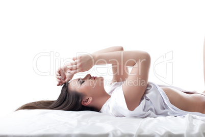 Portrait of sexy young brunette lying in studio