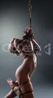 Image of graceful nude girl hanging on rope