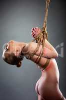 Image of beautiful naked girl bound rope